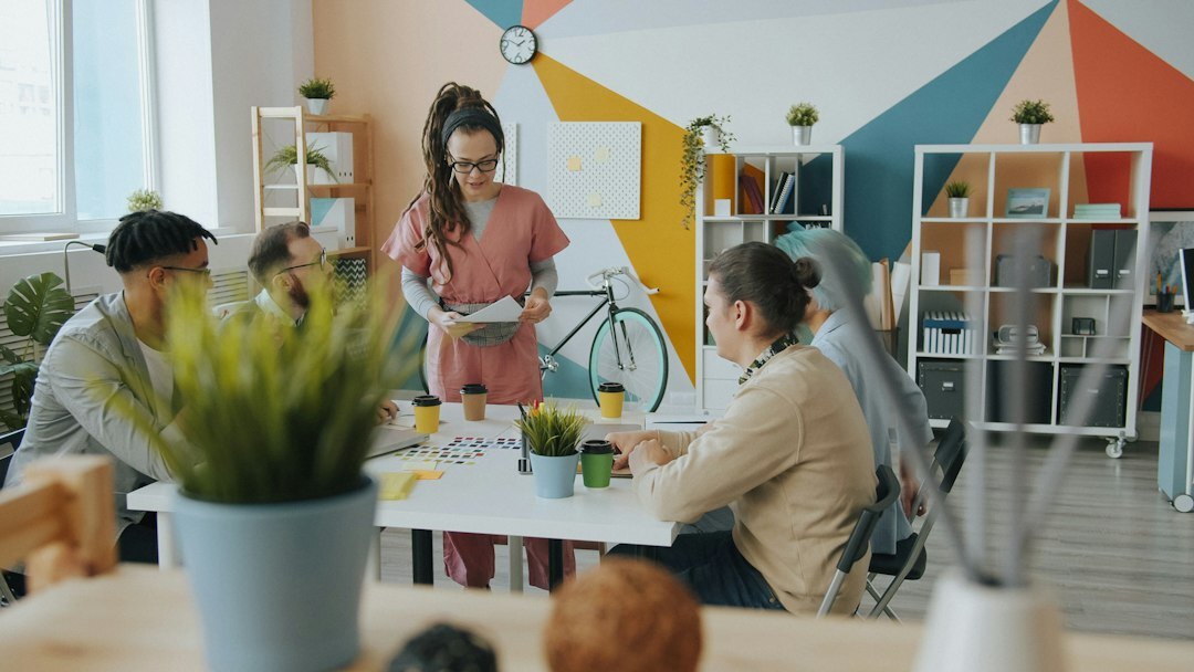 Researchers collaborating around a table with printed charts and laptops in a bright modern institute office in Germany